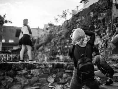 photographers taking photo of young woman