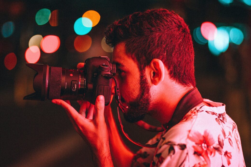 man holding dslr camera